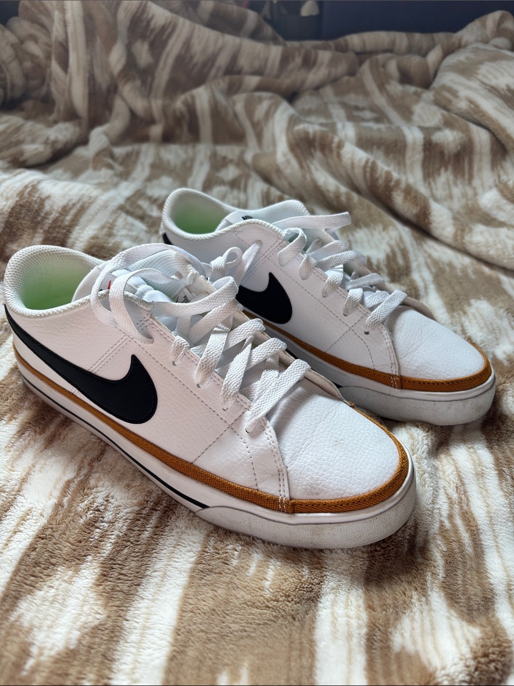 Nike White Low-Top Sneakers with Black Swoosh and Brown Trim Accent